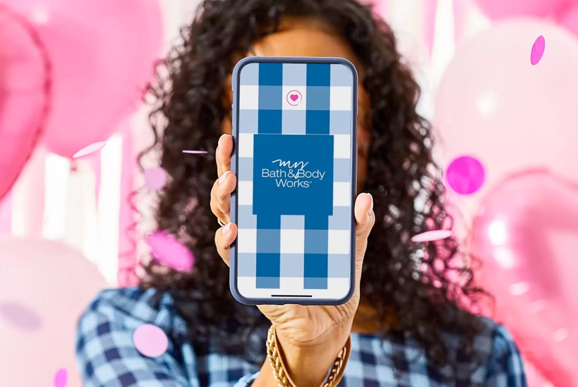 Person holding a phone with the My Bath & Body Works app on the screen.