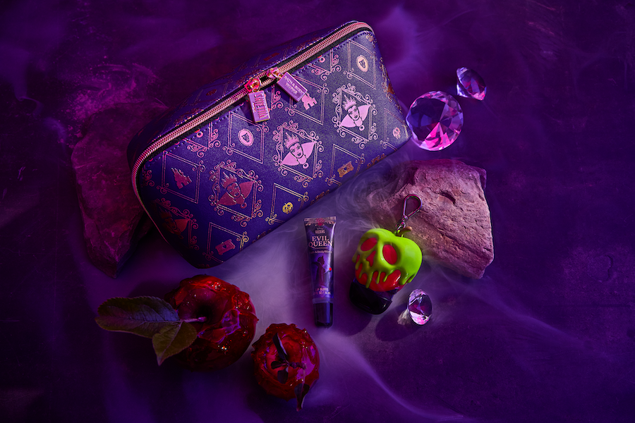 Products from Bath & Body Works Disney Villains collection on rocks, with purple back lighting