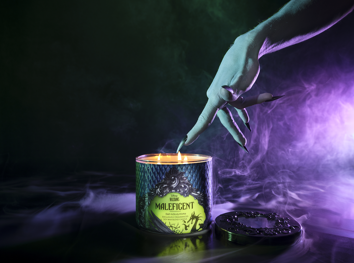 3-wick candle from Bath & Body Works Disney Villains collection on a smoky background with a witch-like hand