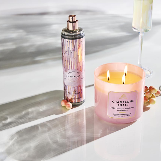 Champagne Toast fine fragrance mist and 3-wick candle on lifestyle imagery