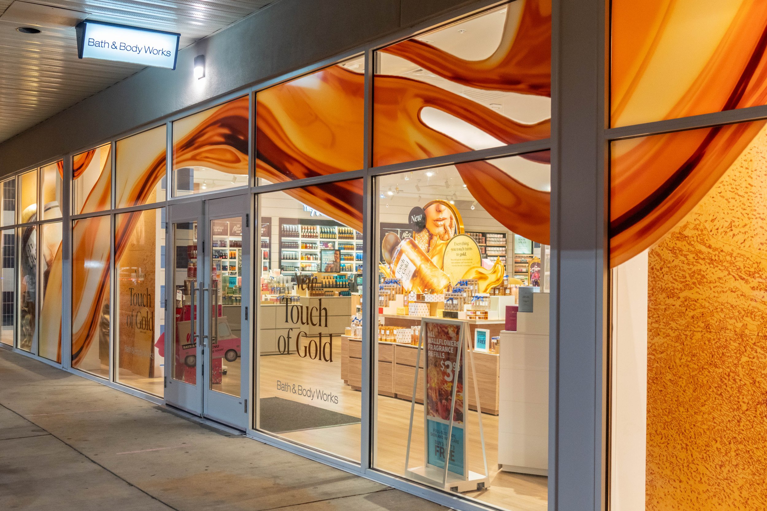 Photo of Bath & Body Works store with gold decorated windows