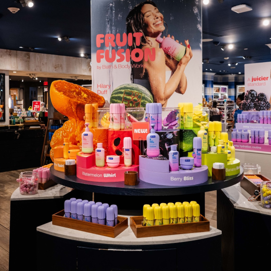 Three Fruit Fusion Product stands with photos of Hilary Duff in a Bath & Body Works store