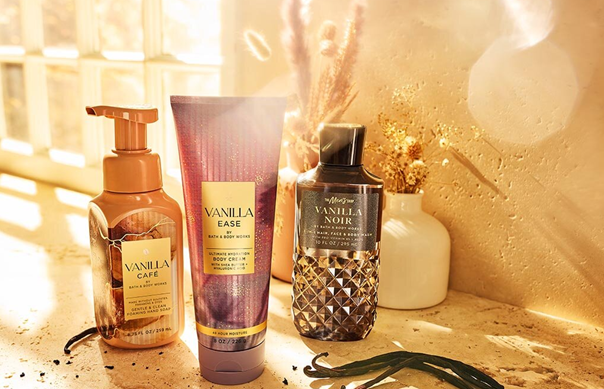 Bath & Body Works Vanilla body care products on stone with warm lighting