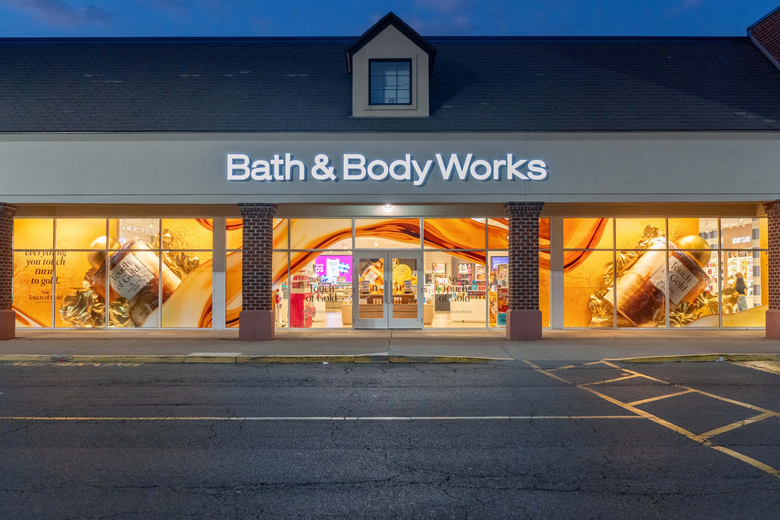 Photo of Bath & Body Works store with gold decorated windows