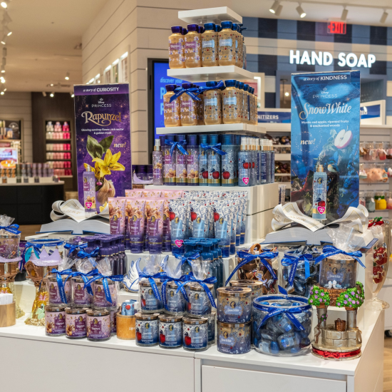 Rapunzel and Snow White product stand in a Bath & Body Works store