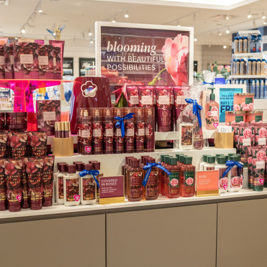 Rose and Covered in Roses product stand in a Bath & Body Works store