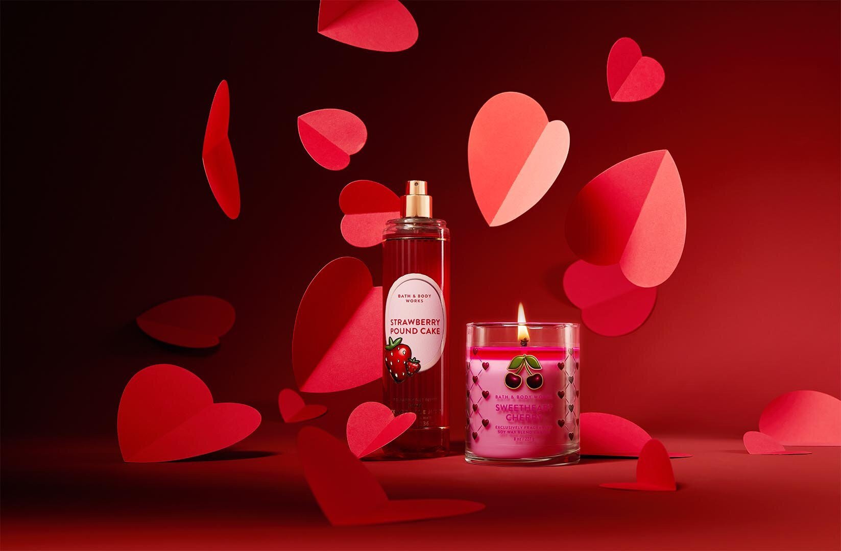 Bath & Body Works fine fragrance mist and single wick candle with flying red hearts on a red background